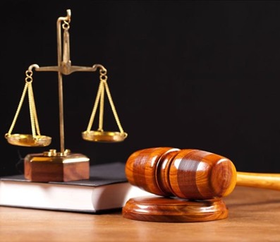 A close-up of a gavel and scales of justice